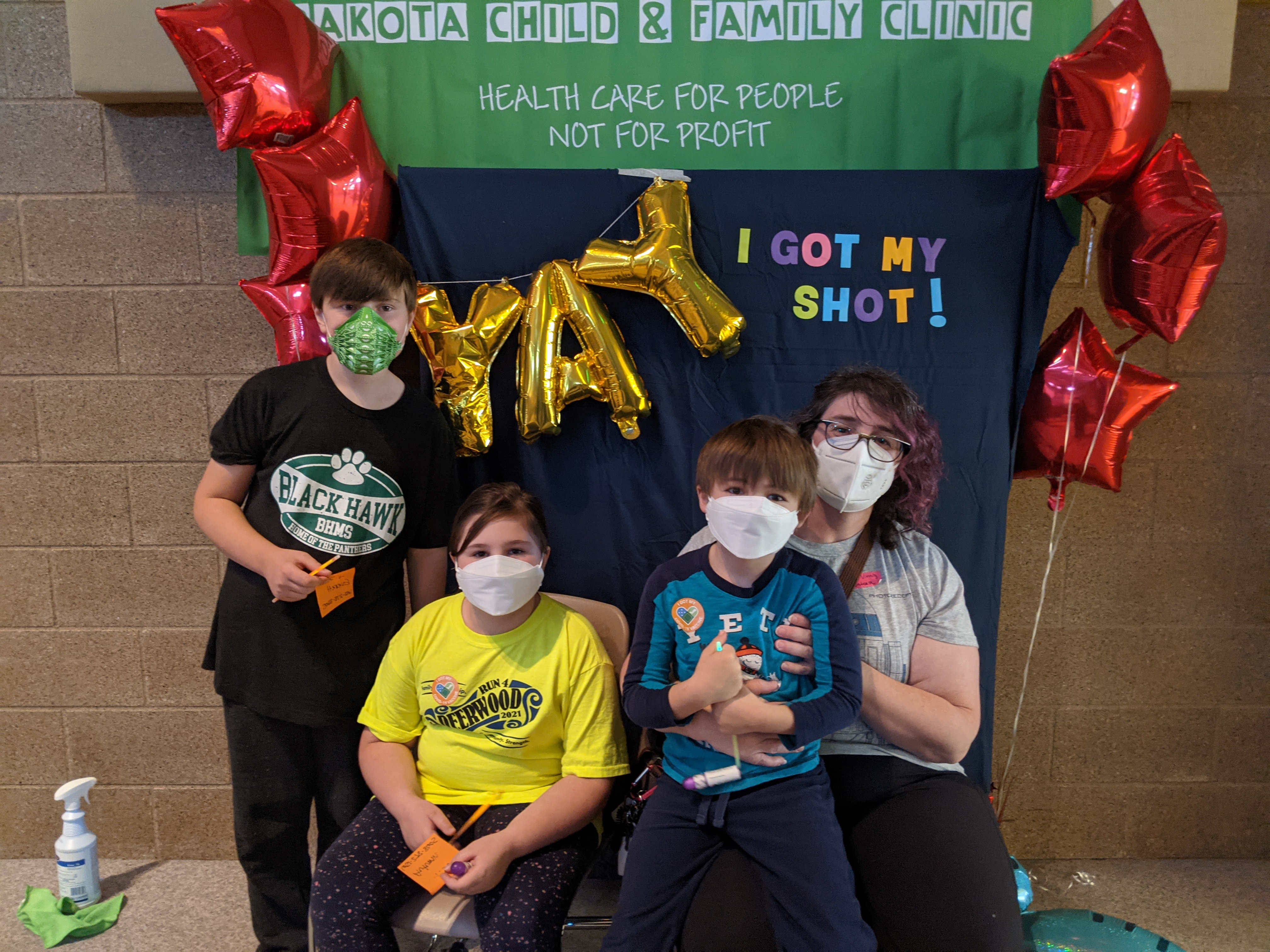 Photo of students and parent after they receive their first Covid-19 vaccine