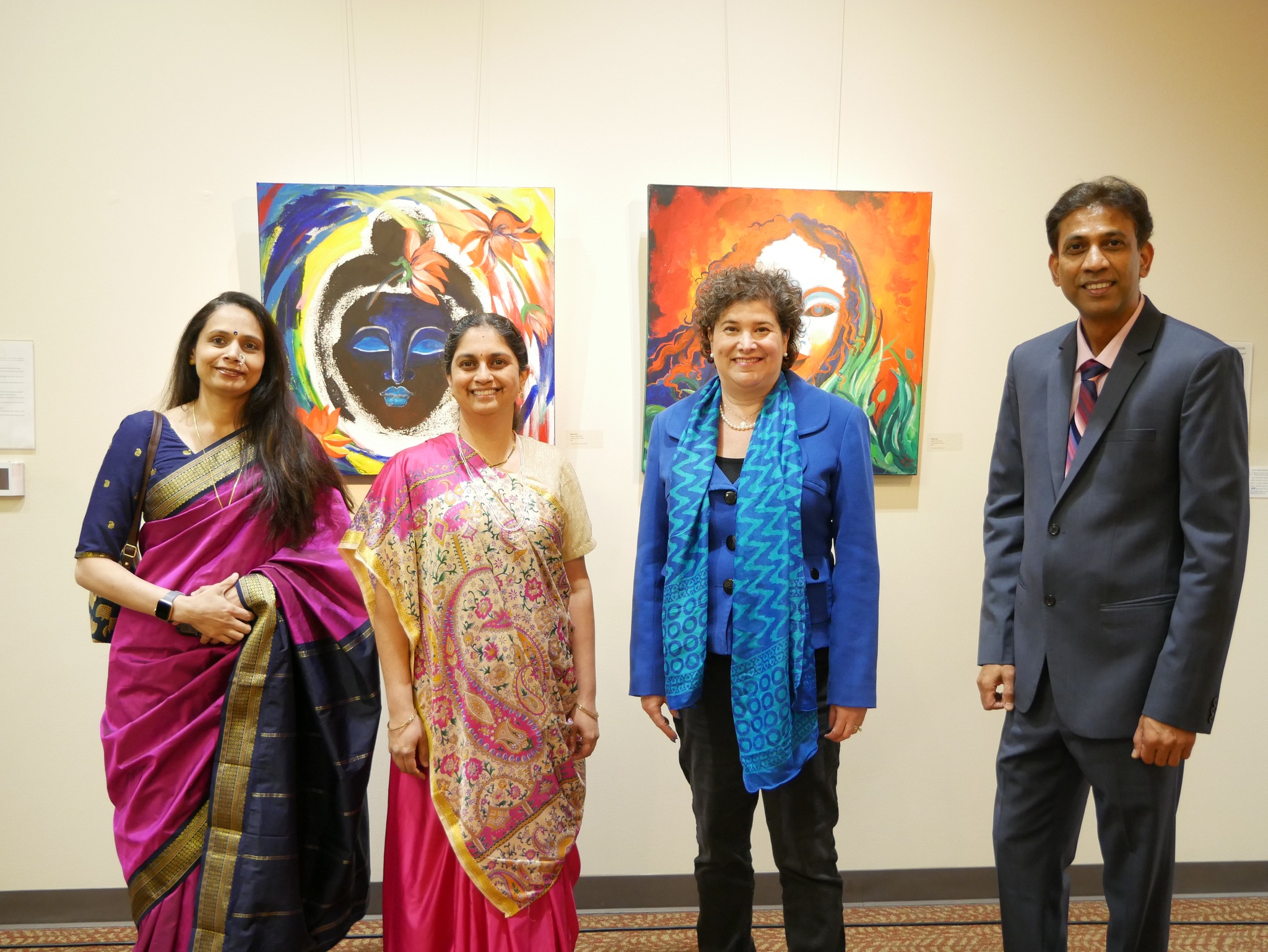 standing with artists in front of a painting